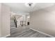 Spacious living area with wood floors and access to the second story stairs at 8116 Haywood Estate Ave, Las Vegas, NV 89113