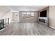 Living room showcasing natural light, modern fireplace, and sleek hardwood flooring at 8116 Haywood Estate Ave, Las Vegas, NV 89113