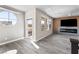 Living room features an electric fireplace, large windows, and hardwood floors at 8116 Haywood Estate Ave, Las Vegas, NV 89113