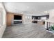 Open-concept living space with a modern kitchen, fireplace, and plenty of natural light at 8116 Haywood Estate Ave, Las Vegas, NV 89113
