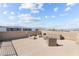 Enjoy the outdoors on this expansive rooftop deck with stylish seating and a fire pit perfect for entertaining with city views at 8116 Haywood Estate Ave, Las Vegas, NV 89113