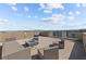 Entertain on this rooftop deck featuring contemporary outdoor seating, a fire pit, and stunning views of the cityscape at 8116 Haywood Estate Ave, Las Vegas, NV 89113