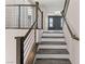 Modern staircase with wood steps, white risers and sleek metal railing at 8116 Haywood Estate Ave, Las Vegas, NV 89113