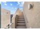 Exterior staircase, with stucco walls and a metal handrail, leading to an upper level at 8116 Haywood Estate Ave, Las Vegas, NV 89113