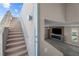 Staircase with textured walls, contemporary lighting, and a glimpse of the living room at 8116 Haywood Estate Ave, Las Vegas, NV 89113