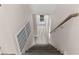 Bright stairwell features wood treads, light walls, and plenty of light near a door leading outdoors at 8116 Haywood Estate Ave, Las Vegas, NV 89113