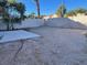 Backyard featuring a concrete patio area, with trees in the background providing privacy and shade at 8244 Sickle Ln, Las Vegas, NV 89128