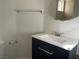Bathroom features a sleek vanity with modern fixtures, accompanied by a stylish round mirror and convenient towel rack at 8244 Sickle Ln, Las Vegas, NV 89128