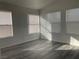 Well-lit bedroom featuring modern flooring and multiple windows for ample natural light at 8244 Sickle Ln, Las Vegas, NV 89128