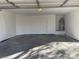 Spacious two car garage with ample room for parking and storage and a water heater on a raised platform at 8244 Sickle Ln, Las Vegas, NV 89128