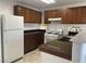 Functional kitchen with dark wood cabinets, granite countertops, and modern white appliances at 8244 Sickle Ln, Las Vegas, NV 89128