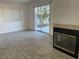 Bright living room with sliding glass doors opening to the yard and featuring a cozy fireplace at 8244 Sickle Ln, Las Vegas, NV 89128