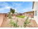 Landscaped backyard featuring a patio, artificial turf, and rock groundcover at 9629 Grouse Grove Ave, Las Vegas, NV 89148
