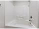 Close-up of a white tiled bathtub and shower combination at 9629 Grouse Grove Ave, Las Vegas, NV 89148