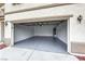 A clean, empty garage with a gray epoxy floor and a modern garage door at 9629 Grouse Grove Ave, Las Vegas, NV 89148