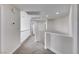 Upstairs hallway features neutral carpeting, crisp white walls and railing at 9629 Grouse Grove Ave, Las Vegas, NV 89148
