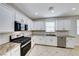 A spacious kitchen features stainless steel appliances, white cabinetry, and granite countertops at 9629 Grouse Grove Ave, Las Vegas, NV 89148