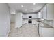 A well-lit open kitchen features white cabinetry, granite countertops, and stainless steel appliances at 9629 Grouse Grove Ave, Las Vegas, NV 89148