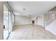 Open living room offers tiled flooring, a fireplace and natural light from sliding glass doors at 9629 Grouse Grove Ave, Las Vegas, NV 89148
