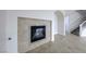 Bright living room showcases a fireplace, tiled flooring, and an adjacent staircase at 9629 Grouse Grove Ave, Las Vegas, NV 89148