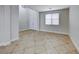 This living room offers neutral paint, white trim, double door closet and large front window at 9629 Grouse Grove Ave, Las Vegas, NV 89148