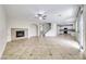 Spacious living room features tiled floors, a fireplace, and access to an open concept kitchen at 9629 Grouse Grove Ave, Las Vegas, NV 89148