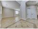 Spacious living room featuring stylish tile flooring, white trim, and abundant natural light at 9629 Grouse Grove Ave, Las Vegas, NV 89148