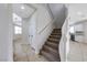 Carpeted staircase with white railing, connecting to the kitchen and other rooms at 9629 Grouse Grove Ave, Las Vegas, NV 89148