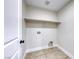 A small storage room or closet featuring tile floors and a shelf at 9629 Grouse Grove Ave, Las Vegas, NV 89148