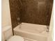 Bathroom features a soaking tub with brown granite-look surround at 9739 Fox Estate St, Las Vegas, NV 89141