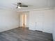 Spacious bedroom with modern gray flooring, ceiling fan and multiple doors at 9739 Fox Estate St, Las Vegas, NV 89141