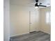 Bedroom features modern gray flooring, ceiling fan and shuttered window at 9739 Fox Estate St, Las Vegas, NV 89141