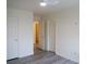 Bright bedroom with modern gray flooring, two closets and white ceiling fan at 9739 Fox Estate St, Las Vegas, NV 89141