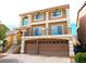 Two-story home featuring a balcony, a two-car garage and a landscaped front yard at 9739 Fox Estate St, Las Vegas, NV 89141