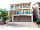 Two-story home featuring a balcony, a two-car garage and a landscaped front yard at 9739 Fox Estate St, Las Vegas, NV 89141