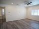 Bright living room features wood-look flooring, ceiling fan, and plantation shutters at 9739 Fox Estate St, Las Vegas, NV 89141