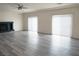 Bright living room featuring vinyl flooring, a fireplace, and large windows at 9739 Fox Estate St, Las Vegas, NV 89141