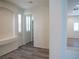 Arched entry to living area features wood-look flooring, built-in bench, and plantation shutters at 9739 Fox Estate St, Las Vegas, NV 89141