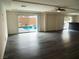 Spacious living room offers wood-look flooring and access to the pool area at 9739 Fox Estate St, Las Vegas, NV 89141
