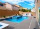 A pool and raised spa with a fire pit at 9739 Fox Estate St, Las Vegas, NV 89141