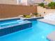A pool and raised spa with a view of backyard at 9739 Fox Estate St, Las Vegas, NV 89141