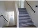Staircase features wood-look steps and a black metal railing at 9739 Fox Estate St, Las Vegas, NV 89141