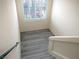 Bright stairwell with grey wood-look flooring, white walls and shuttered window at 9739 Fox Estate St, Las Vegas, NV 89141