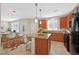 Modern kitchen area featuring granite countertops, a functional island, and an adjacent dining setup at 10449 Yew Blossom Ave, Las Vegas, NV 89166