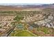 Panoramic aerial view of a Primary-planned community with parks, tennis courts, and stunning mountain views at 11283 Gravitation Dr, Las Vegas, NV 89135