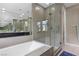 Luxurious bathroom with a soaking tub and glass-enclosed walk-in shower at 11283 Gravitation Dr, Las Vegas, NV 89135