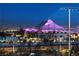 Night view of a cityscape with a uniquely lit building in the foreground at 11283 Gravitation Dr, Las Vegas, NV 89135
