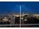 Evening view of a cityscape and stadium lit up in the distance at 11283 Gravitation Dr, Las Vegas, NV 89135
