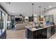 Bright, modern kitchen with breakfast bar overlooking the living area at 11283 Gravitation Dr, Las Vegas, NV 89135