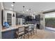 Modern kitchen with stainless appliances, dark cabinets, and breakfast bar with seating at 11283 Gravitation Dr, Las Vegas, NV 89135